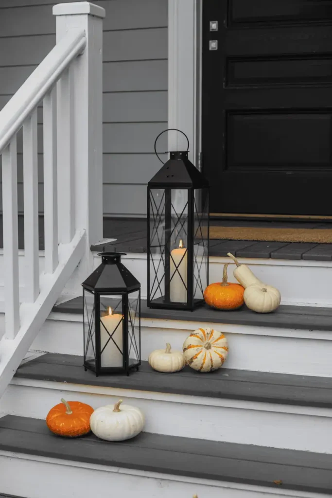 Rustic farmhouse lanterns glowing with candles for Halloween.
