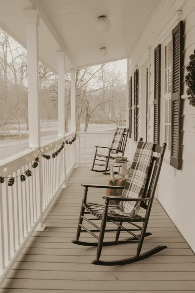 Rustic holiday porch with twinkle lights and farmhouse décor.