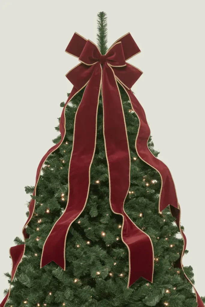 Luxury Christmas tree topper with oversized velvet bow.